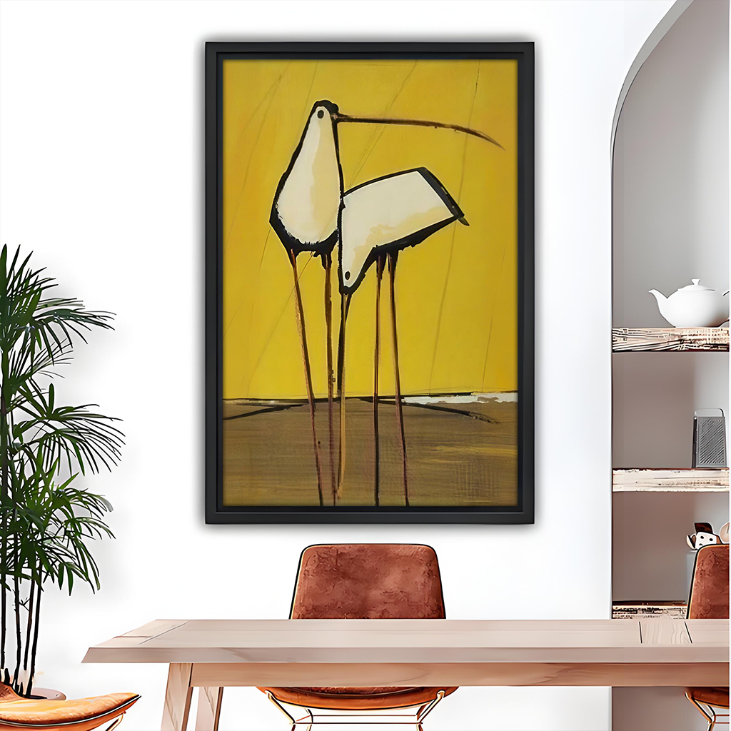 Black-framed abstract birds canvas wall art with a mustard yellow background above a wooden dining table.