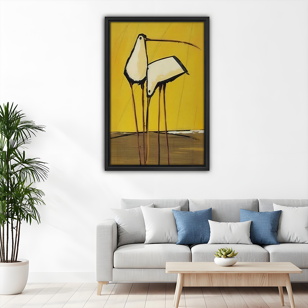 Black-framed abstract birds canvas wall art above a gray sofa with blue and white pillows.