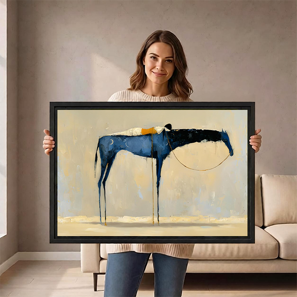 Woman holding a large framed abstract blue horse wall art print showing drip paint texture and black frame, demonstrating print scale