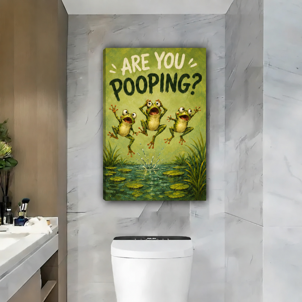Unframed gallery-wrap are you pooping frogs canvas wall art displayed on a marble bathroom wall above the toilet.