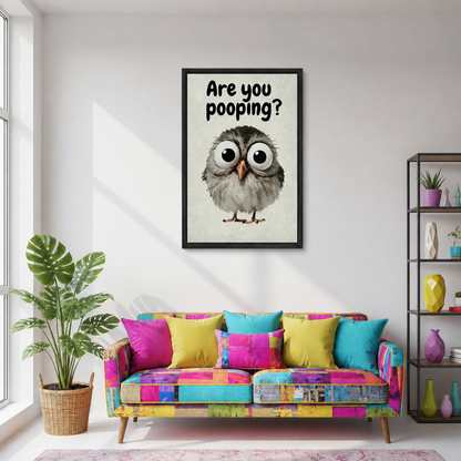 Framed are you pooping owl canvas wall art displayed above a colorful patchwork sofa in a living room.