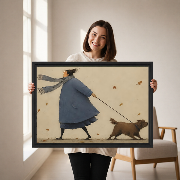 Woman holds framed autumn dog walk canvas wall art featuring a blue-coated walker and shaggy brown dog.