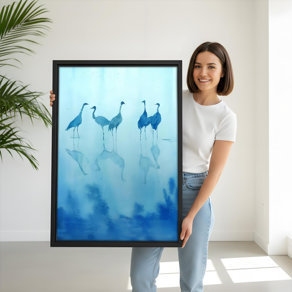 Blue crane watercolor framed canvas art, black frame, woman holding serene bird reflection print, zen nature wall art for living room and bedroom