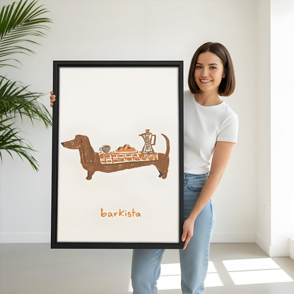 Woman holding black-framed dachshund coffee canvas wall art with barkista lettering and a whimsical café illustration on cream.