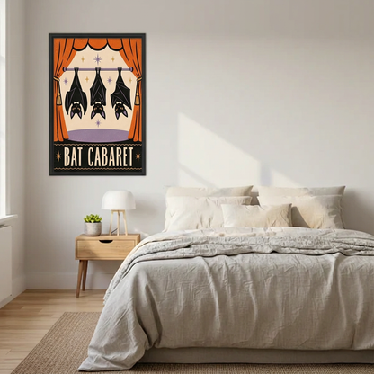 Black-framed Bat Cabaret canvas wall art beside a bed with neutral bedding and a wooden nightstand.