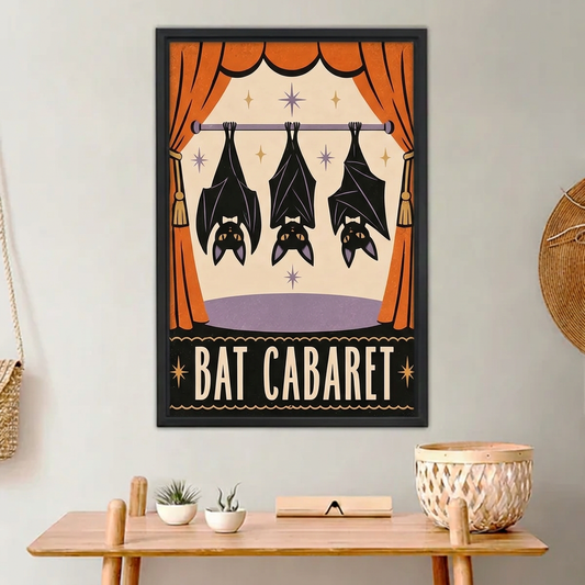 Black-framed Bat Cabaret canvas wall art above a wooden console with small plants and a woven basket.