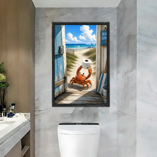 Framed beach crab canvas wall art showing a crab holding toilet paper above a colorful patchwork living room sofa.