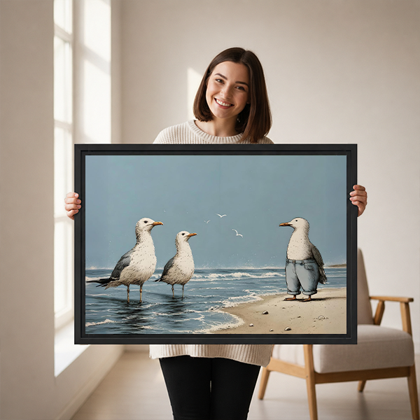 Woman holding black-framed beach seagulls canvas wall art depicting a humorous coastal scene with a trouser-wearing bird.