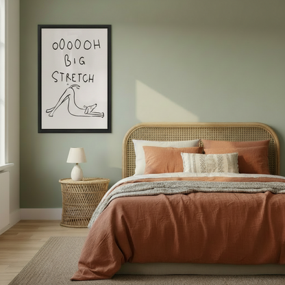 Framed funny dog big stretch wall art hung on sage green bedroom wall above rattan headboard with warm terracotta bedding