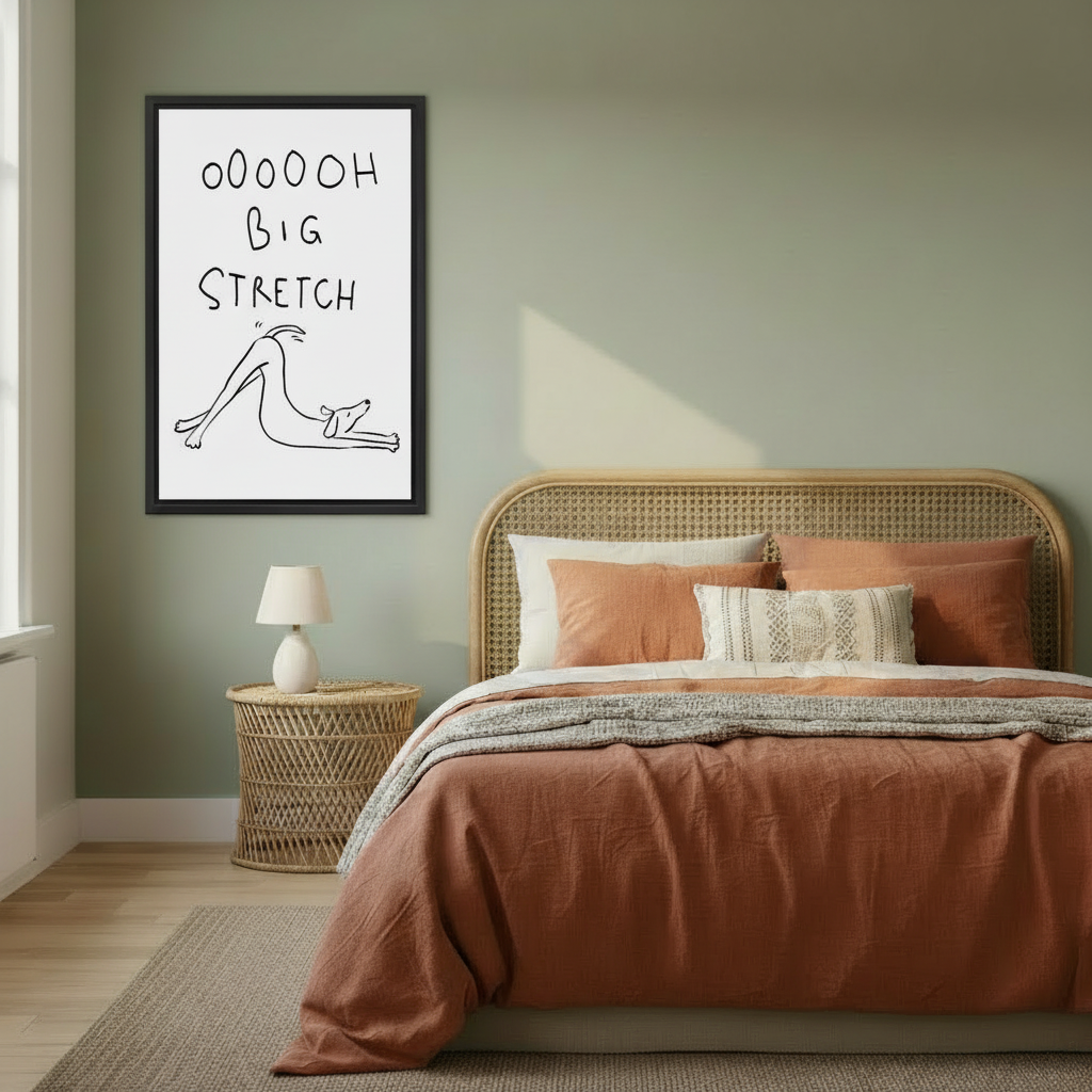 Framed funny dog big stretch wall art hung on sage green bedroom wall above rattan headboard with warm terracotta bedding