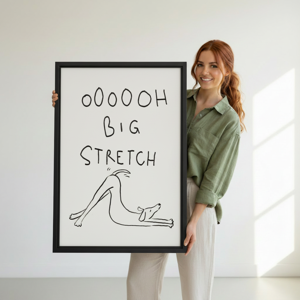 Smiling woman holding large framed funny dog big stretch line art print, showing print size reference against white background