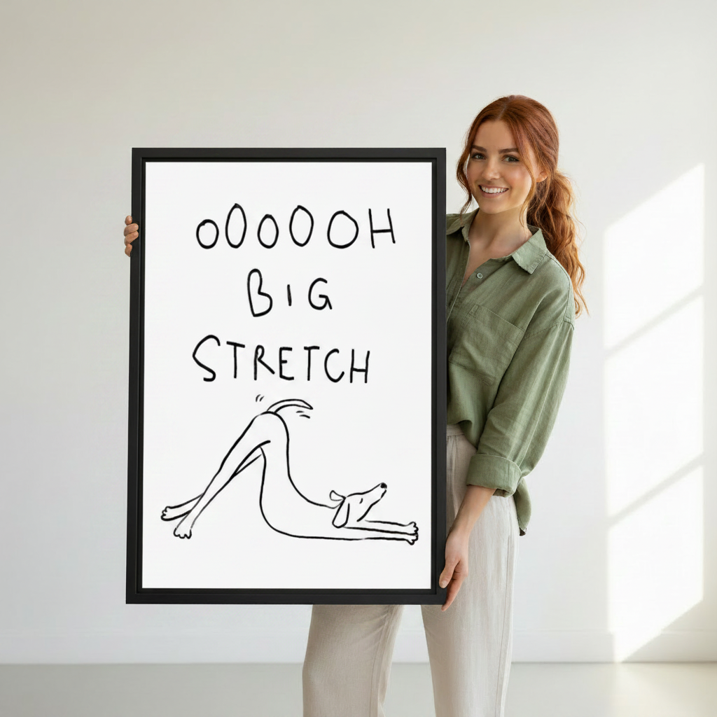 Smiling woman holding large framed funny dog big stretch line art print, showing print size reference against white background