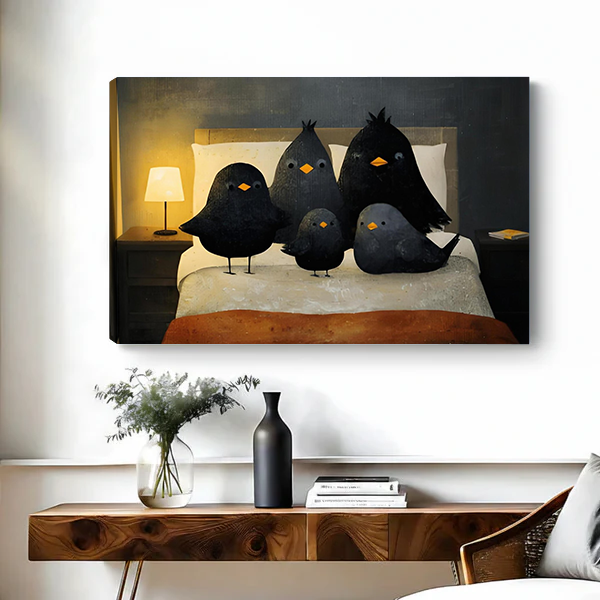 Framed black birds on a bed canvas wall art above a black console table with plants and books