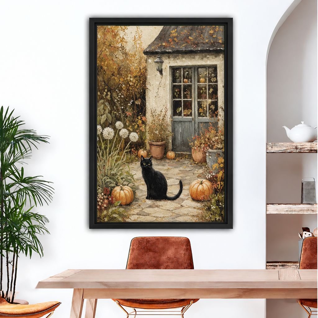 Framed black cat autumn cottage canvas art hanging above a dining table, with pumpkins and a garden path.