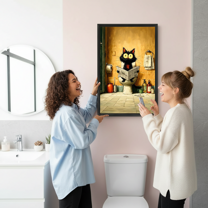 Two women laughing while hanging funny black cat on toilet framed wall art print in modern bathroom