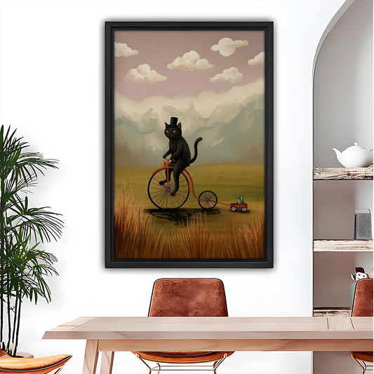 Whimsical black cat bicycle wall art in black frame above a wooden dining table