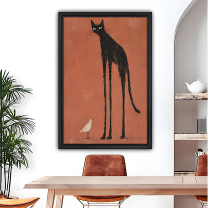 Black cat and bird canvas wall art in a black frame above a dining table beside a potted palm.