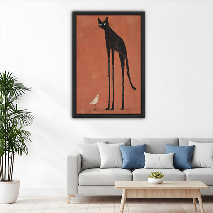 Framed black cat and bird canvas wall art with a tall black silhouette above a gray sofa with blue cushions.