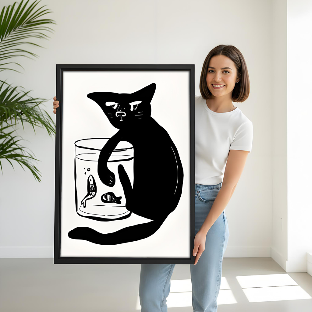 Black-framed black cat and fishbowl canvas wall art above a gray sofa with blue and white cushions.