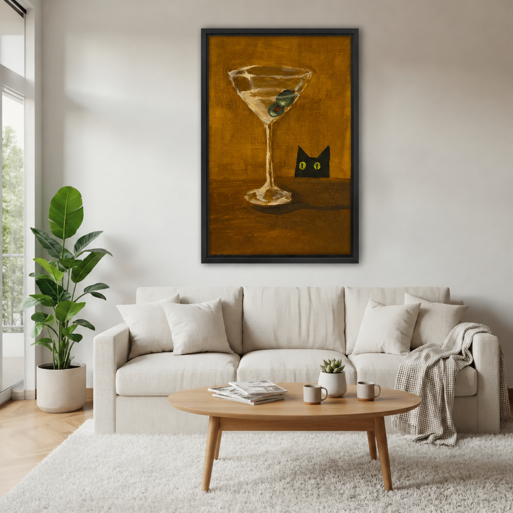 Framed black cat and martini canvas above a cream sofa.