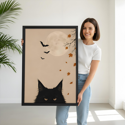 Framed black cat moon canvas wall art shows amber eyes beneath bats above a light sofa.