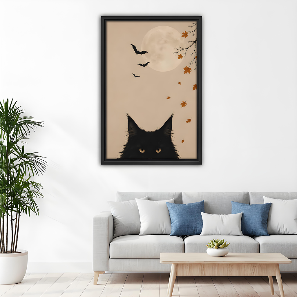 Woman holds framed black cat moon canvas wall art showing a peeking cat, full moon and bats.