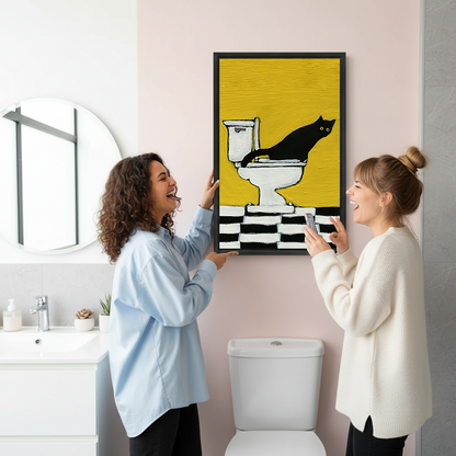 Framed black cat on toilet canvas wall art with a yellow background above a colorful patchwork living room sofa.