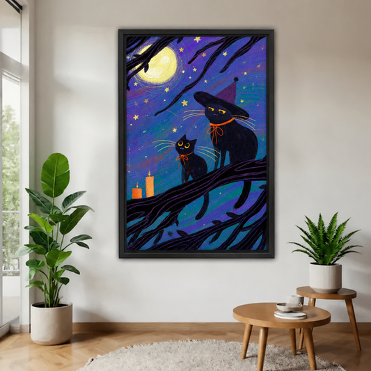 Whimsical black cat Halloween canvas wall art in a black frame on a white wall beside a monstera plant and round wooden side table