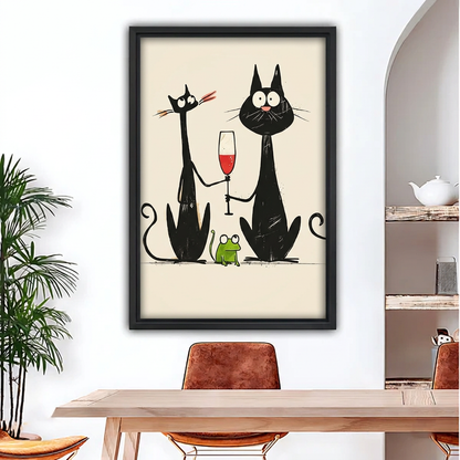 Framed black cats and wine canvas above a wooden dining table.