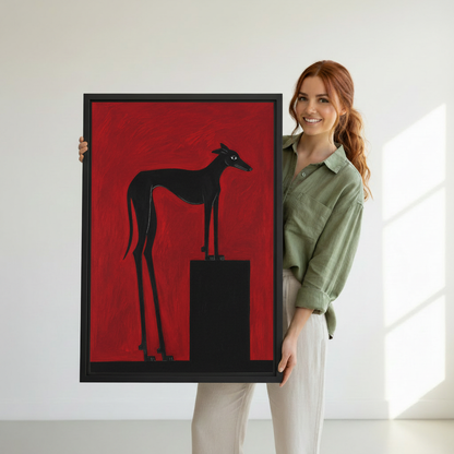 Woman holding oversized black greyhound framed art print, striking red background animal portrait wall decor