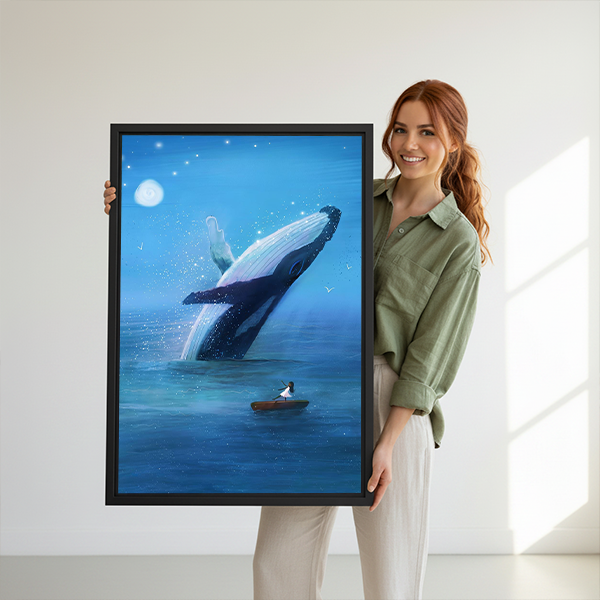 Black-framed breaching whale canvas wall art in luminous blue tones beside a rattan bed with terracotta bedding.