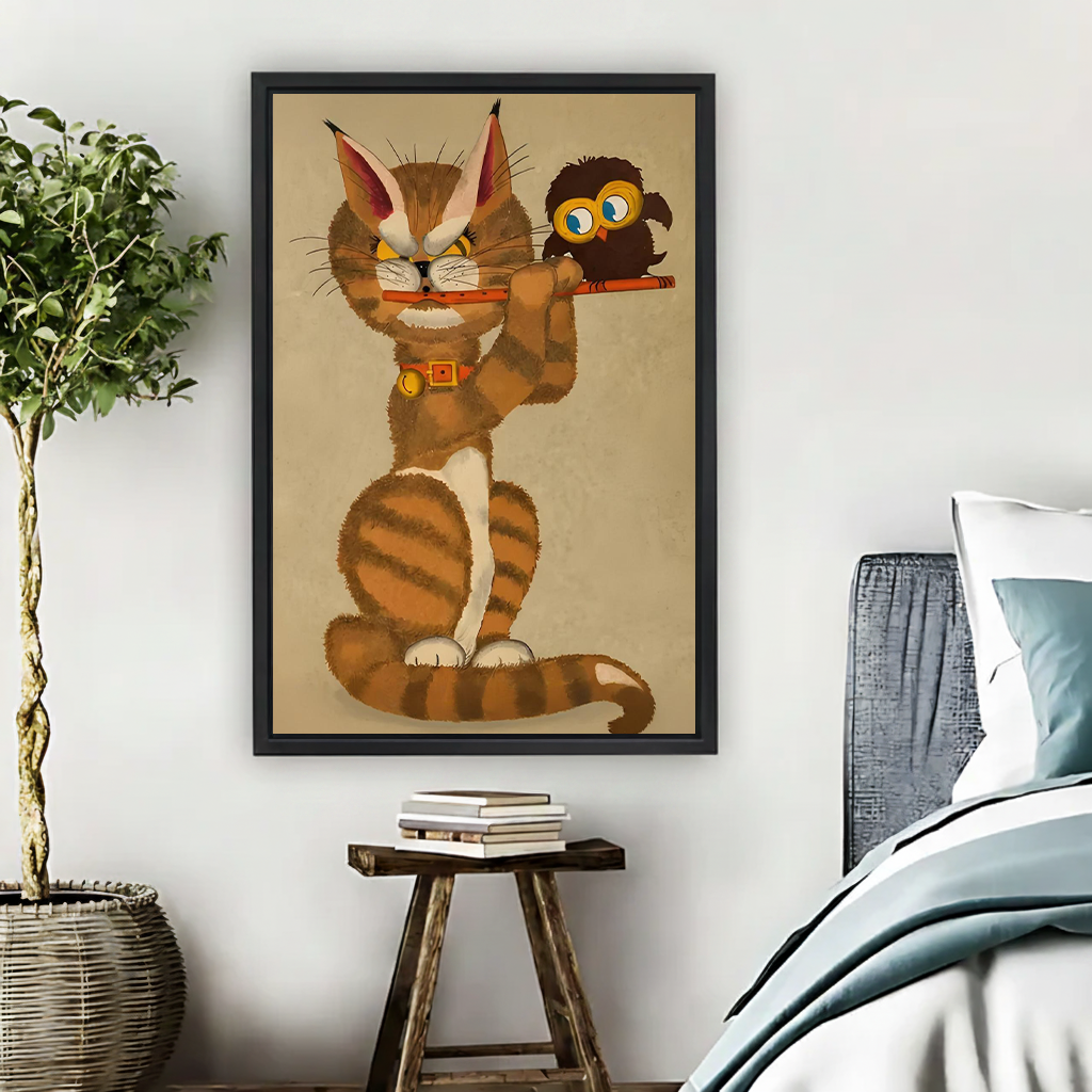 Whimsical cat and owl canvas wall art in a black frame above a light living room sofa.