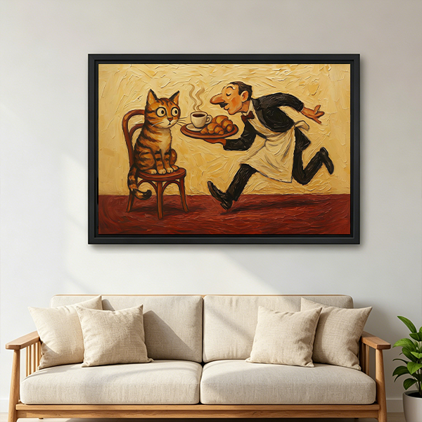 Black-framed whimsical cat and waiter canvas wall art with coffee and pastries above a cream sofa.