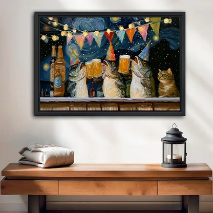 Black-framed cats drinking beer canvas wall art with party hats displayed above a wooden console beside a lantern.