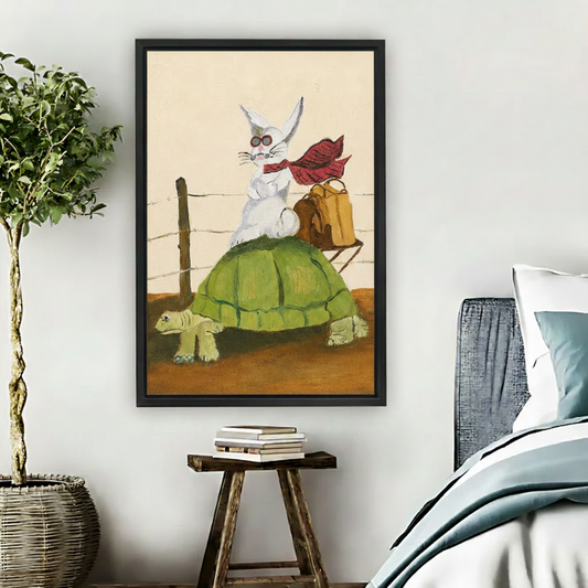 Large black framed wall art of two cartoon cats reading together in a warm library armchair, hung above a wooden stool beside a bed in a minimalist bedroom