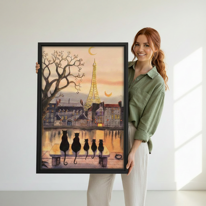 Woman holding large Paris cats framed art print showing actual size reference