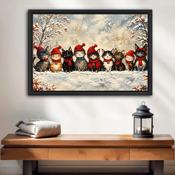 Black-framed Christmas cats canvas wall art above a wooden console table, featuring festive cats in a snowy woodland.