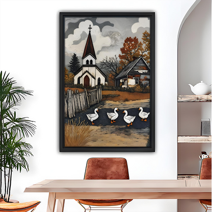Rustic church and geese canvas wall art in a black frame above a dining table beside a potted palm.
