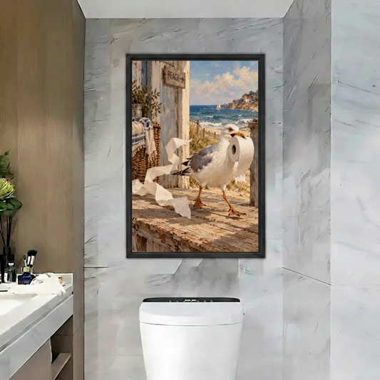 Black-framed coastal seagull wall art featuring blue ocean waves and trailing toilet paper in a gray marble bathroom
