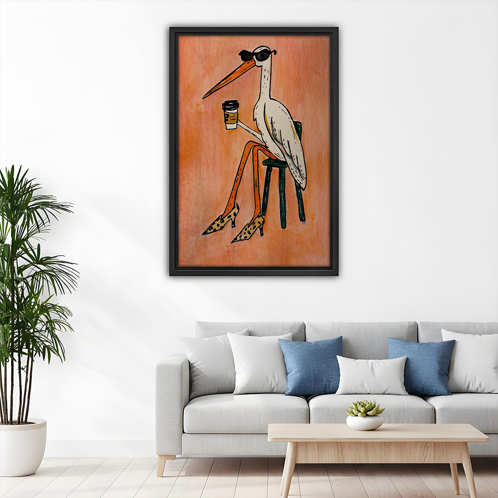 Woman holding black-framed coffee bird canvas wall art featuring a white bird with sunglasses, coffee and patterned heels.
