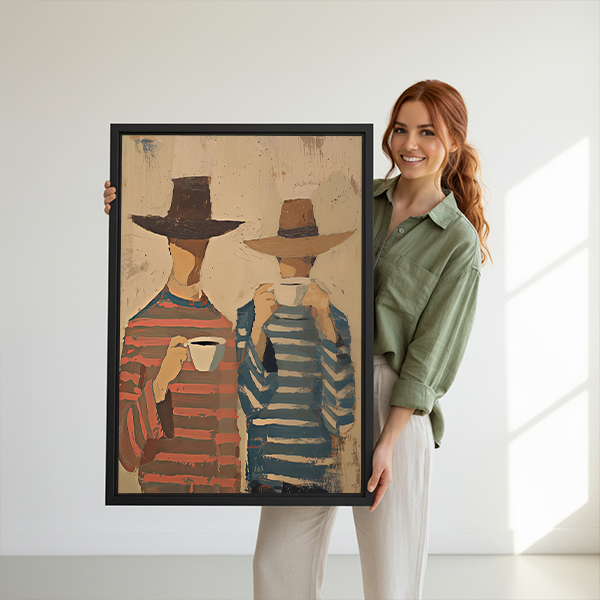 Framed coffee companions canvas wall art showing two figures holding cups beside a rattan bed with rust-colored bedding.