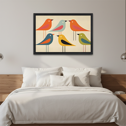 Mid-century colorful birds canvas wall art in a black frame above a cream sofa with wooden armrests.