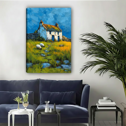 Gallery-wrap country cottage and sheep canvas wall art displayed above a dark blue living room sofa.
