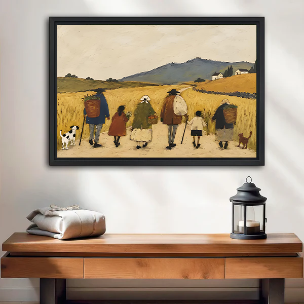 Black-framed countryside walk canvas wall art with golden fields above a wooden console beside a black lantern.
