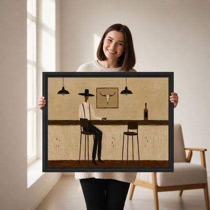 Woman holding framed Western cowboy bar canvas wall art featuring a seated cowboy and an empty stool