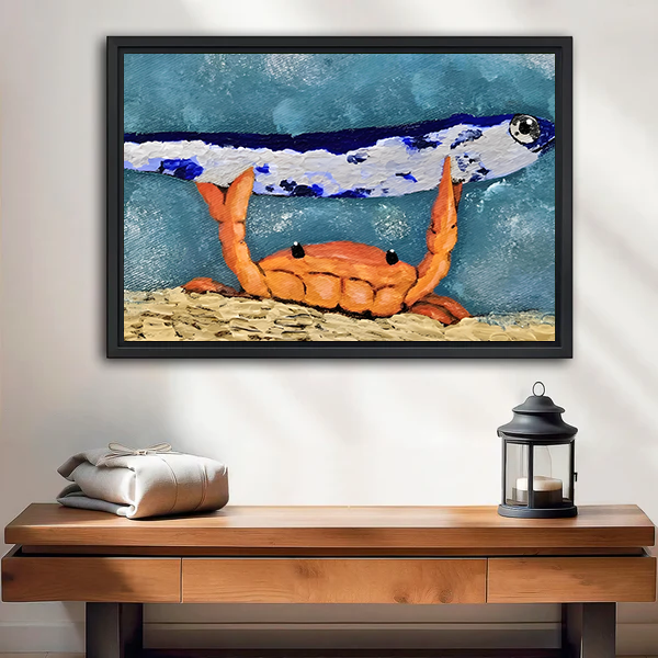Black-framed crab and fish canvas wall art with textured blue tones above a wooden console with a lantern.