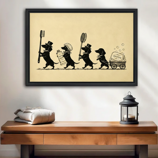 Framed black wall art print of four dachshunds in a vintage parade carrying a toothbrush, toothpaste, brush and savon soap cart, displayed above a wooden console table
