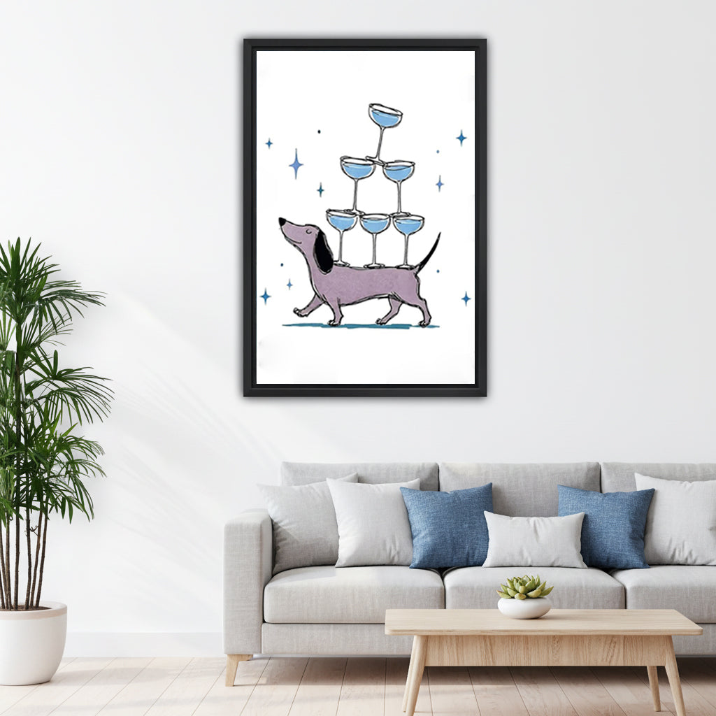 Dachshund cocktail pyramid funny black framed canvas on white wall above gray sofa with blue pillows and wood coffee table