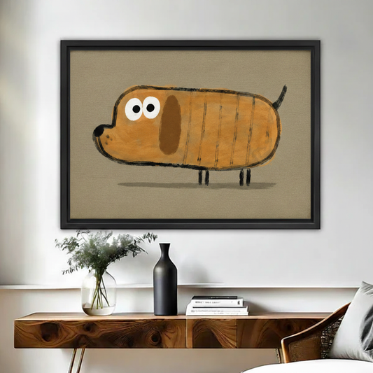 Whimsical dachshund painting in black frame above wooden sideboard with black ceramic vase and eucalyptus