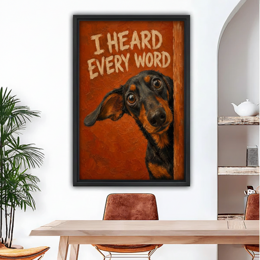 Dachshund dog peeking art print in black frame hung on white wall above wooden dining table